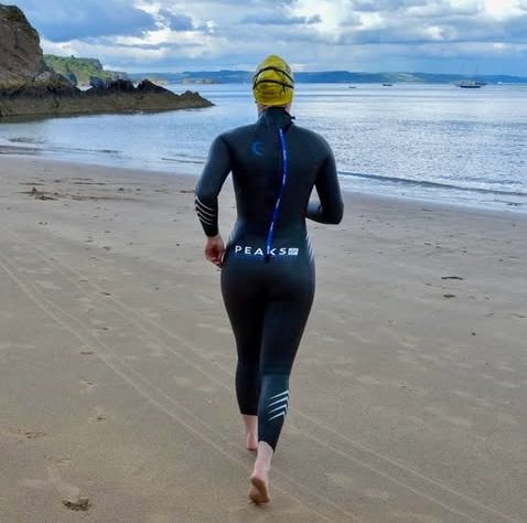 Woman running in wetsuit